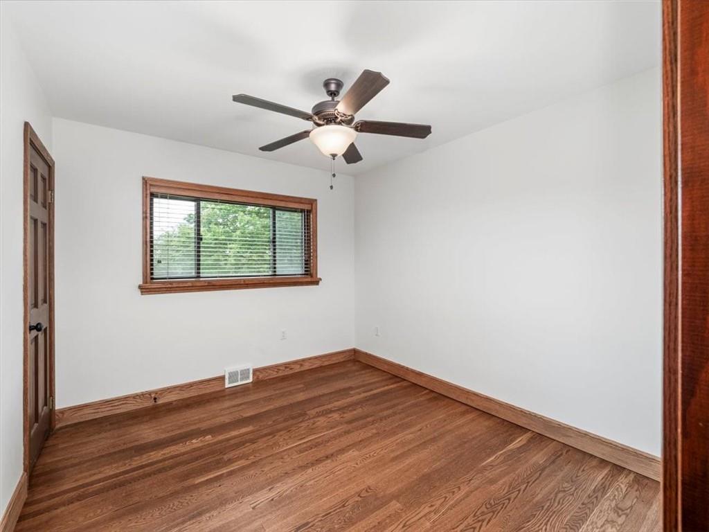 330 Center Grange Road Monaca, PA 15061 - Photo 12 of 42 an empty room with wooden floor fan and windows