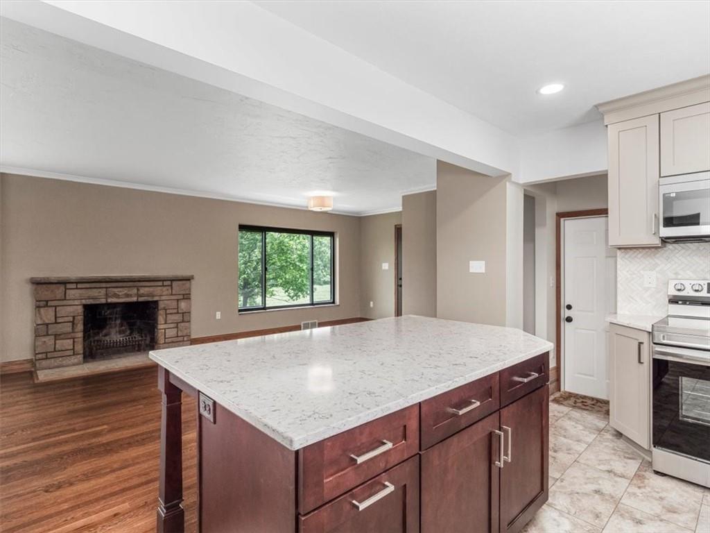 330 Center Grange Road Monaca, PA 15061 - Photo 24 of 42 a kitchen with kitchen island a sink dishwasher a stove and a refrigerator with wooden floor