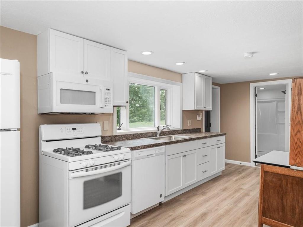 330 Center Grange Road Monaca, PA 15061 - Photo 31 of 42 a kitchen with granite countertop white cabinets and white appliances