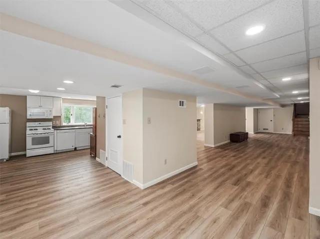 a view of a kitchen with wooden floor and a sink