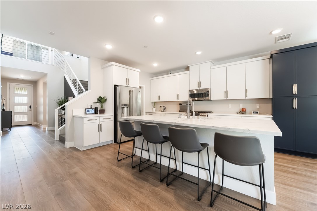 2166 Trivero Street Henderson, NV 89044 - Photo 8 of 61 Culinary creations come to life in this open-concept kitchen, boasting a spacious island and sleek, integrated appliances.