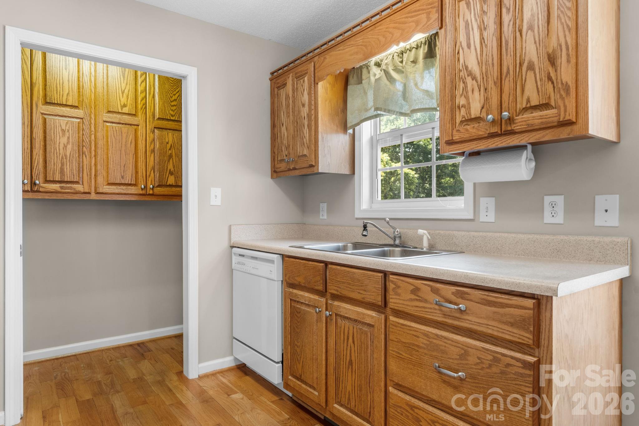 4967 Addison Lane Hickory, NC 28601 - Photo 10 of 43 a kitchen with stainless steel appliances granite countertop a sink and cabinets with wooden floor