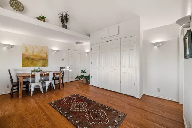 a sitting area with furniture and wooden floor