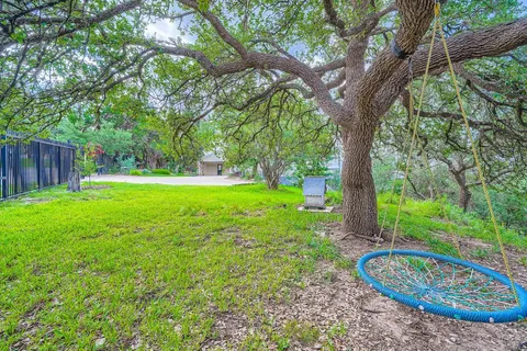 a view of a house with a yard and tree s