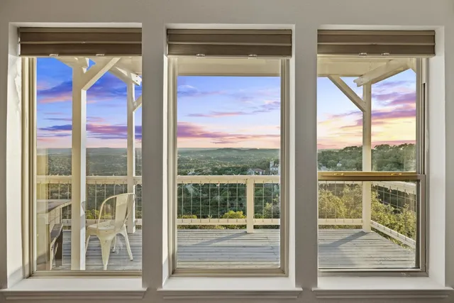 a living room with furniture kitchen view and a wooden floor