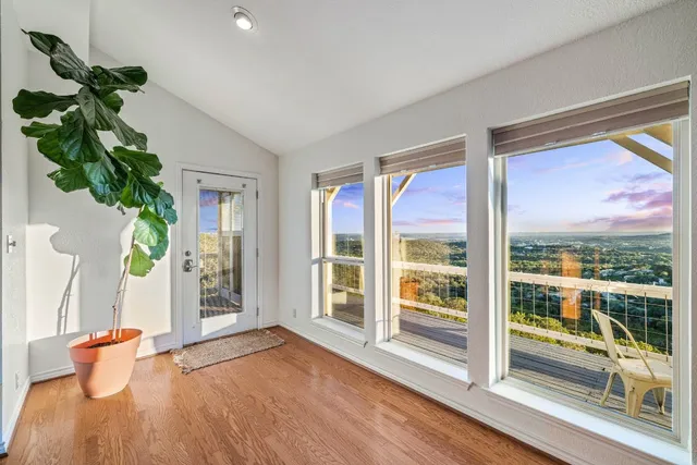a living room with furniture fireplace and a large window