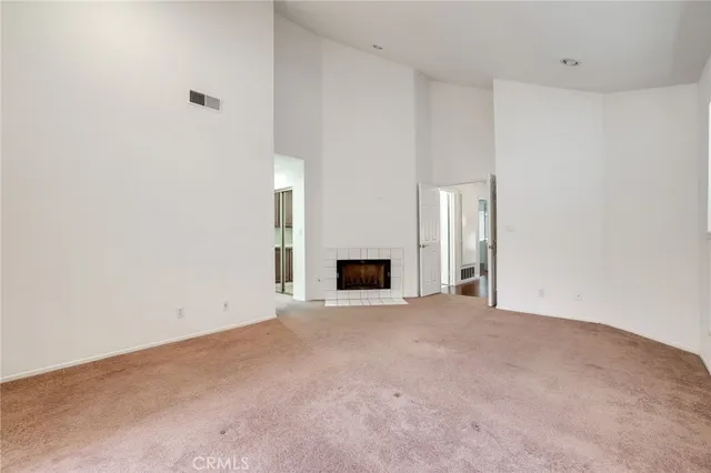 a view of an empty room with a fireplace