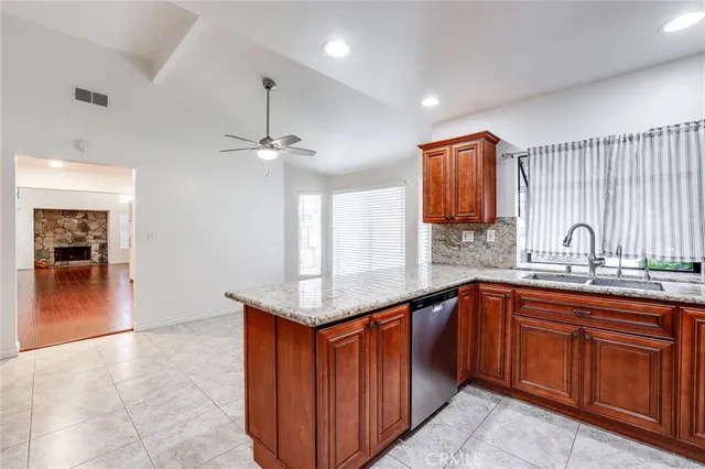 a kitchen with stainless steel appliances granite countertop a sink and cabinets
