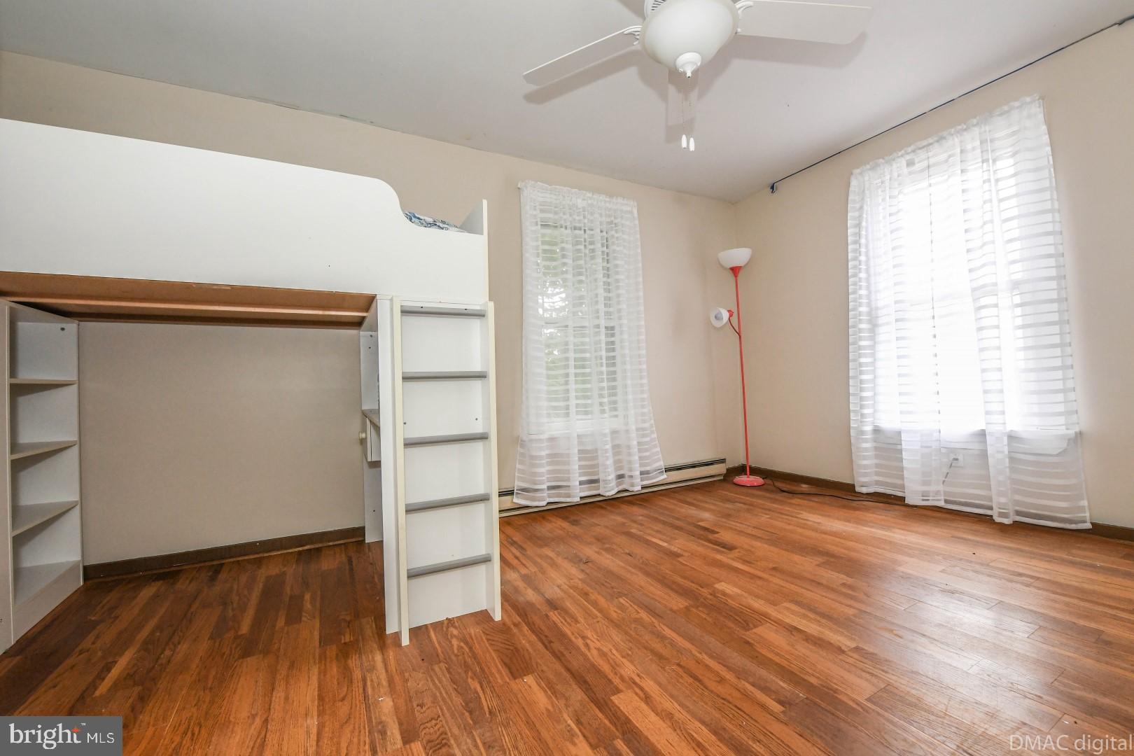 12512 Rockdale Road Clear Spring, MD 21722 - Photo 22 of 31 an empty room with wooden floor cabinet and windows