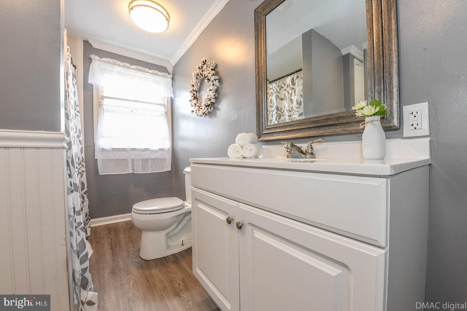 12512 Rockdale Road Clear Spring, MD 21722 - Photo 25 of 31 a bathroom with a toilet sink vanity and mirror