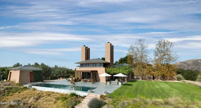 a view of a water fountain in front of a house
