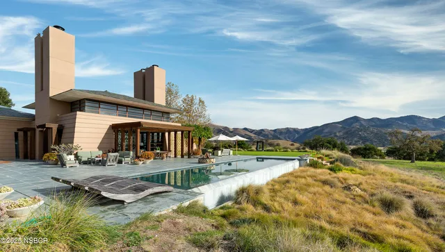 a view of a house with a yard and lake view