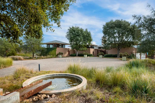 a view of a water fountain in front of house
