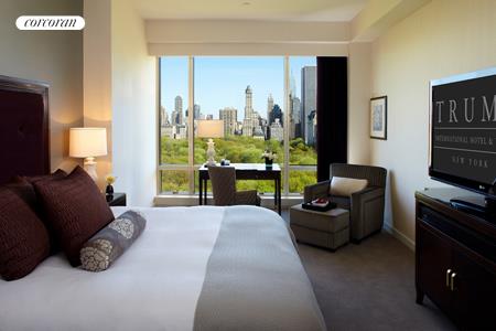 1 Central Park West, Unit 304 Manhattan, NY 10023 - Photo 1 of 10 a living room with furniture a lamp and a window