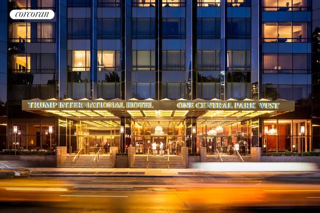 a living room with furniture a lamp and a window