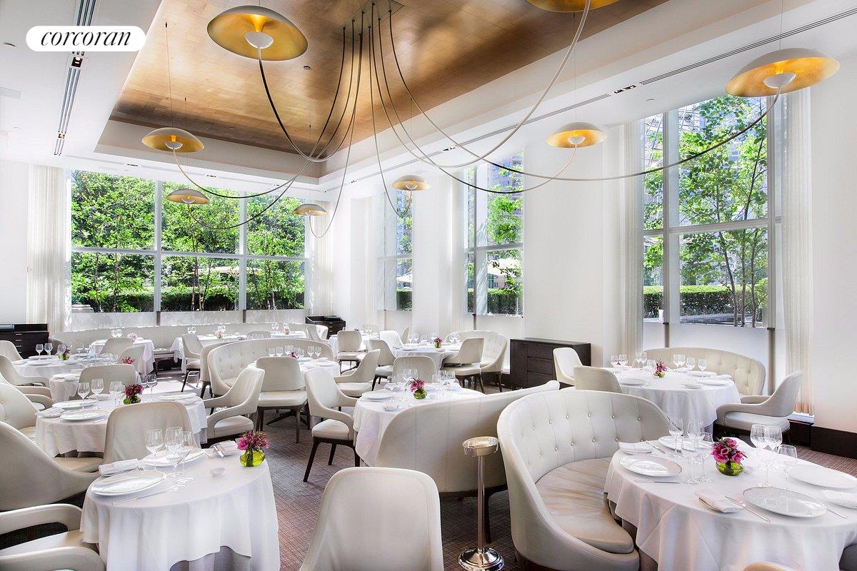 1 Central Park West, Unit 304 Manhattan, NY 10023 - Photo 8 of 10 a living room with furniture and a large window