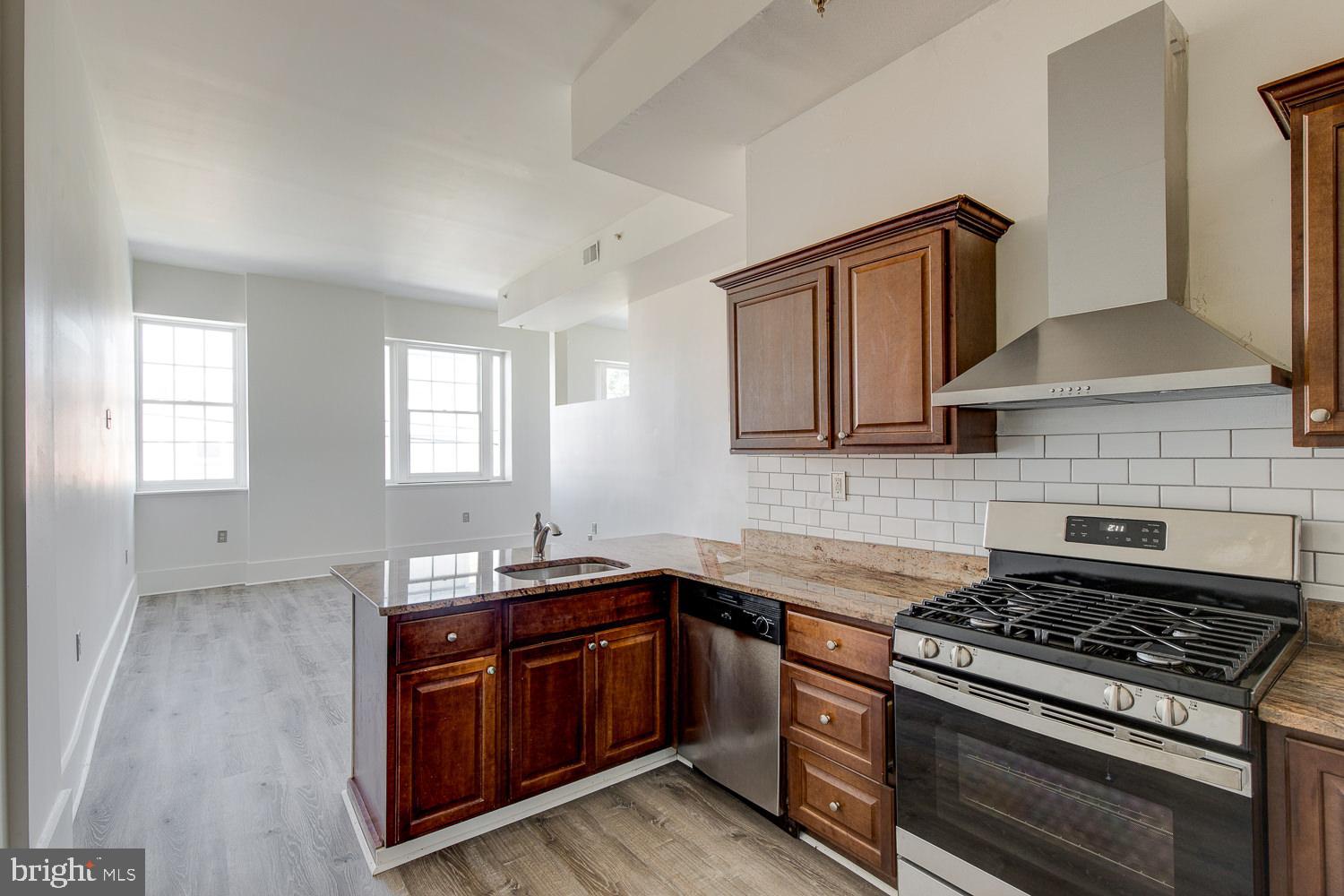 1201 South 5th Street Philadelphia, PA 19147 - Photo 26 of 57 a kitchen with stainless steel appliances granite countertop a sink stove and cabinets