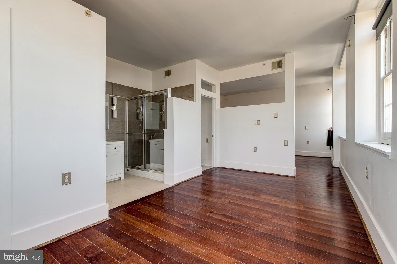 1201 South 5th Street Philadelphia, PA 19147 - Photo 45 of 57 a view of an empty room with wooden floor and a window