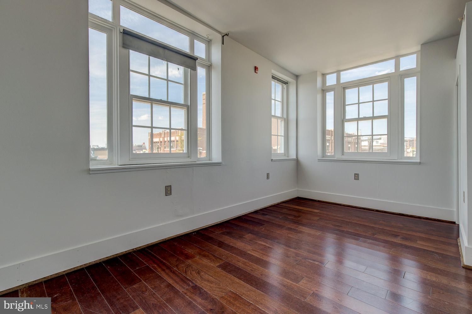 1201 South 5th Street Philadelphia, PA 19147 - Photo 46 of 57 an empty room with wooden floor and windows