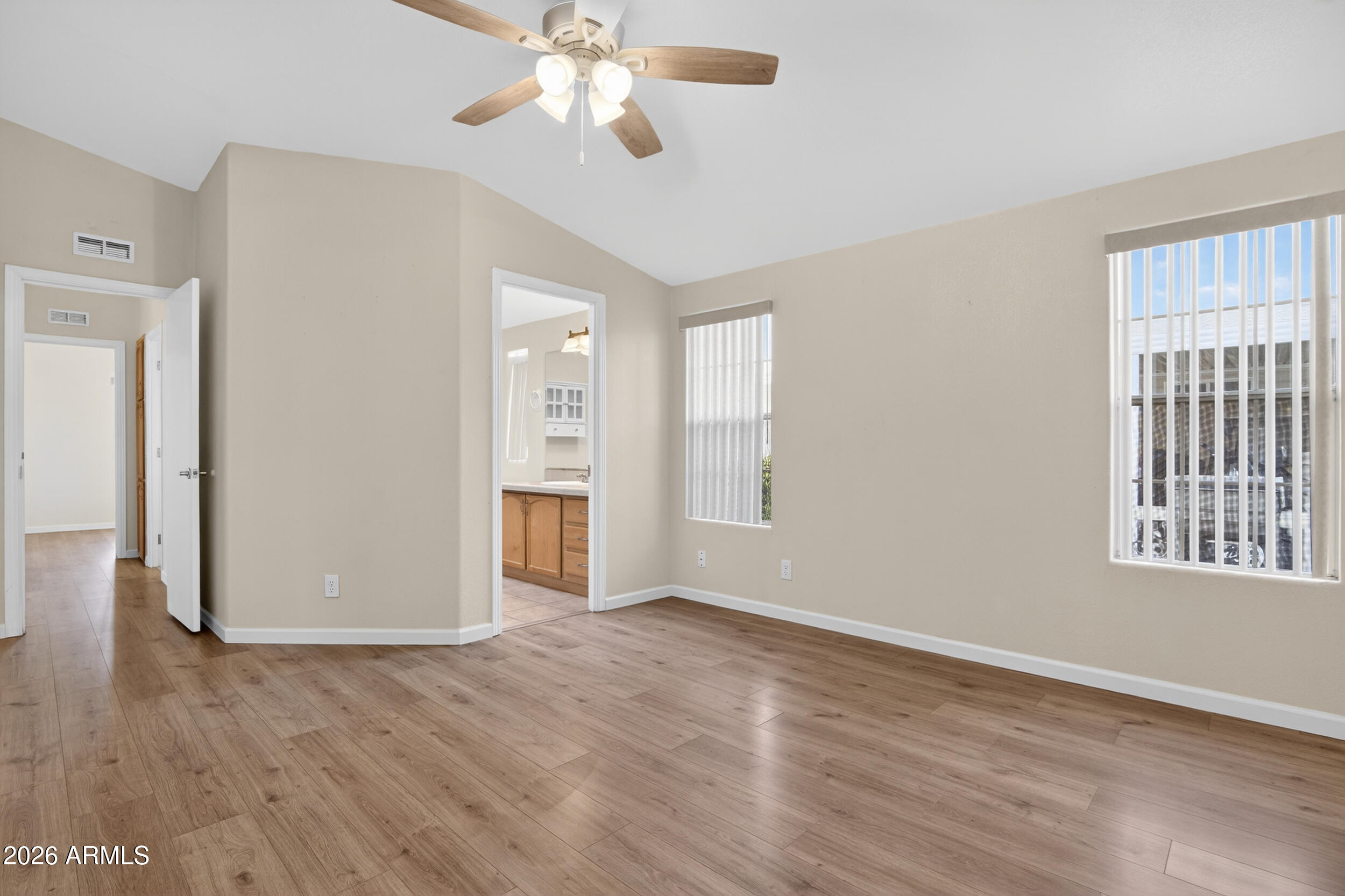 2550 South Ellsworth Road, Unit 396 Mesa, AZ 85209 - Photo 13 of 29 a view of an empty room with a window and wooden floor