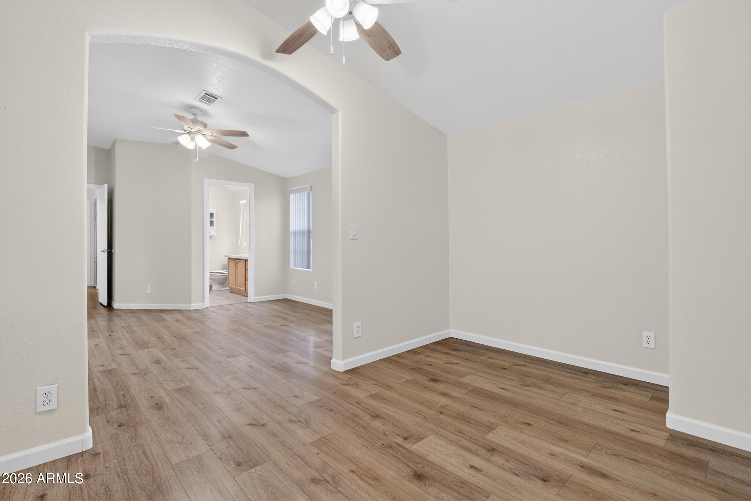 2550 South Ellsworth Road, Unit 396 Mesa, AZ 85209 - Photo 15 of 29 a view of a room with wooden floor and a ceiling fan