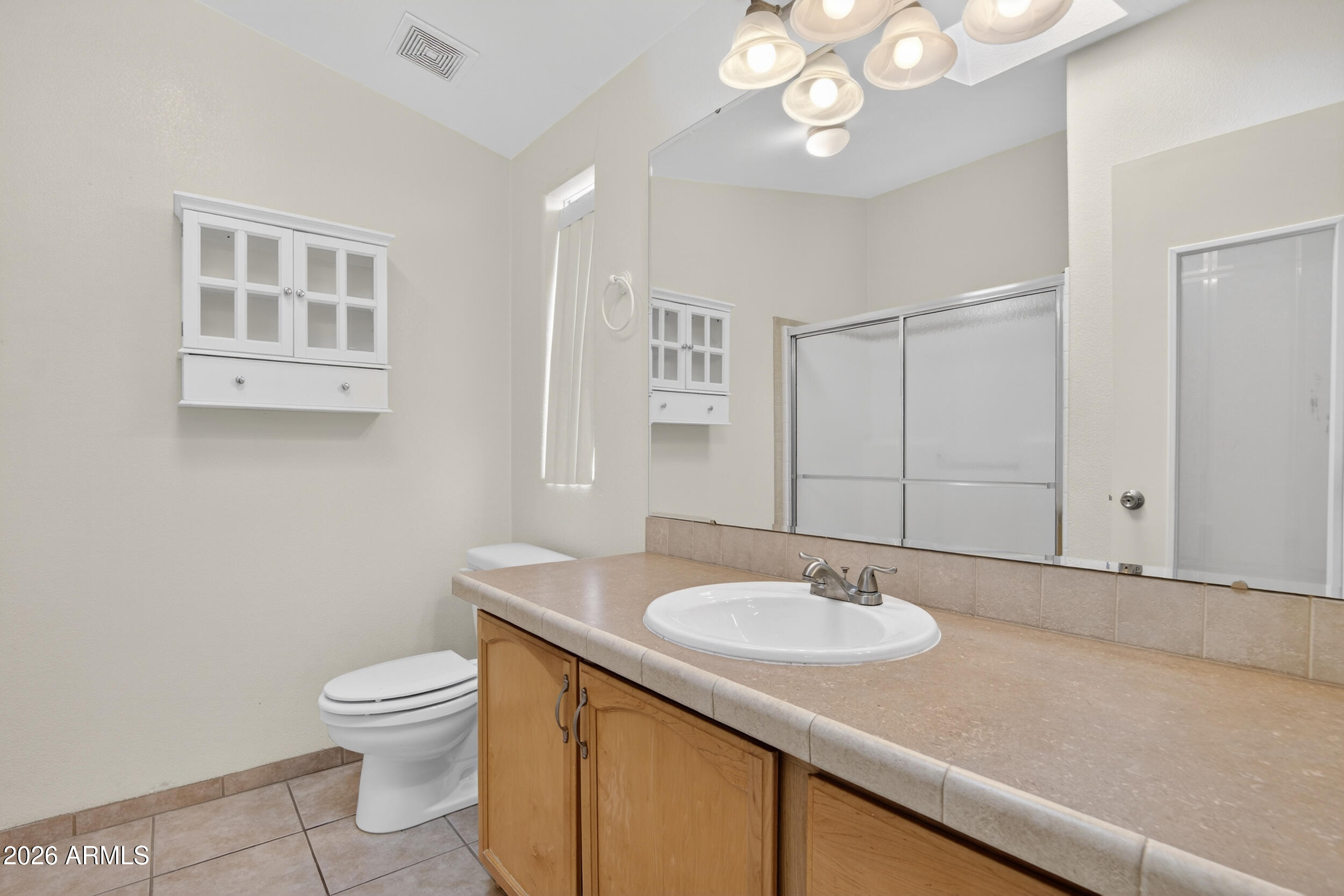 2550 South Ellsworth Road, Unit 396 Mesa, AZ 85209 - Photo 17 of 29 a bathroom with a sink a toilet and a mirror