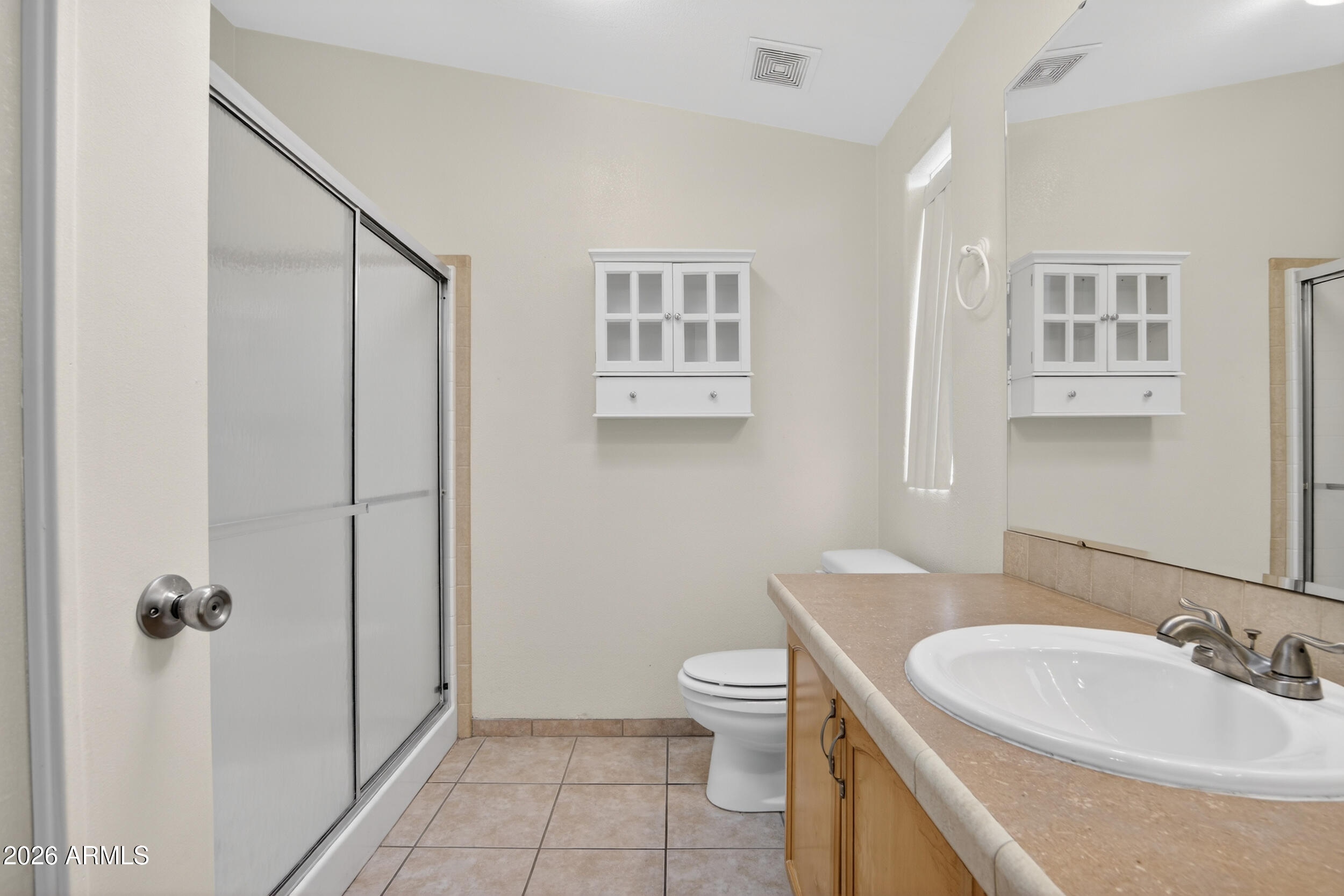 2550 South Ellsworth Road, Unit 396 Mesa, AZ 85209 - Photo 18 of 29 a bathroom with a toilet a sink and shower