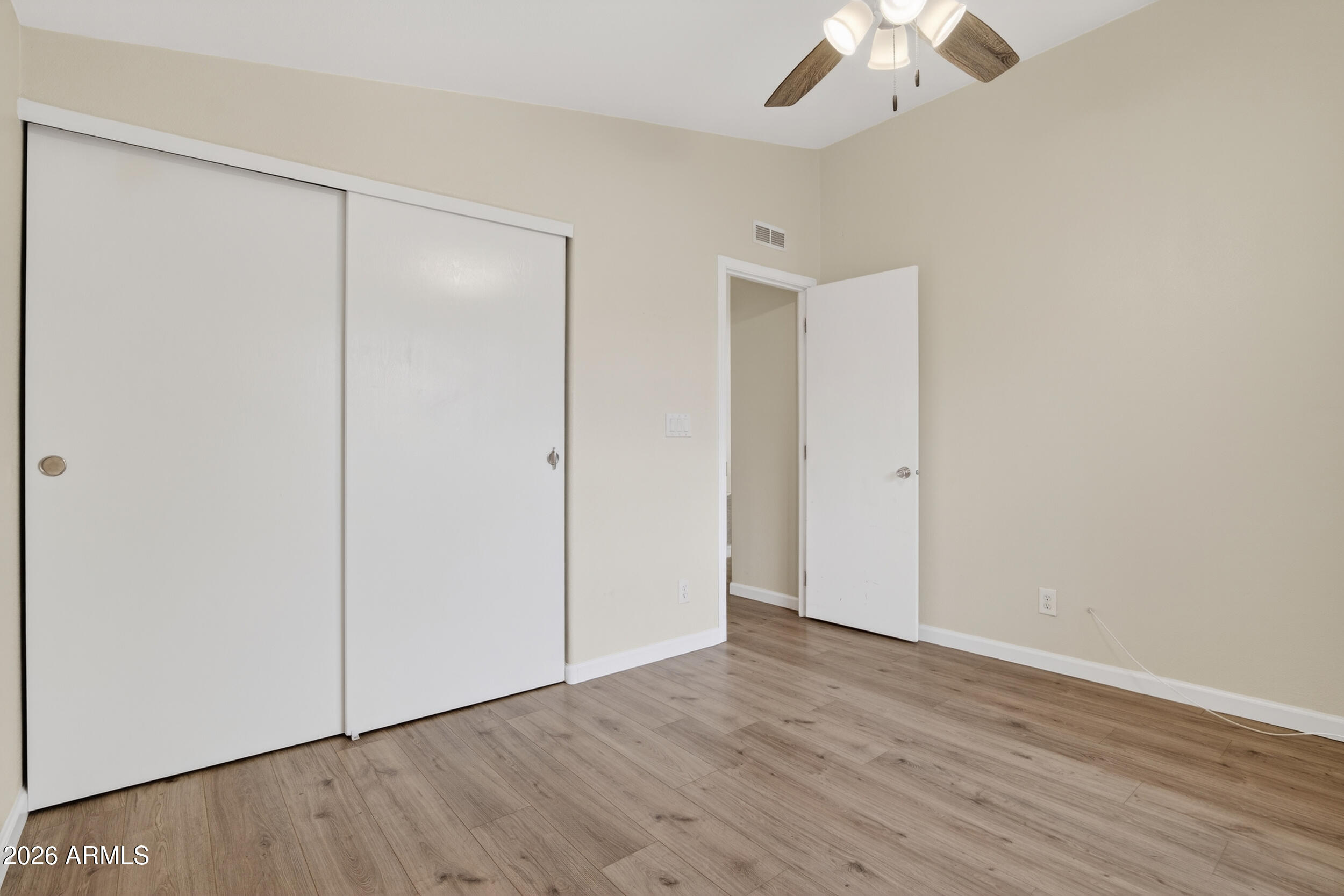 2550 South Ellsworth Road, Unit 396 Mesa, AZ 85209 - Photo 20 of 29 a view of an empty room with wooden floor