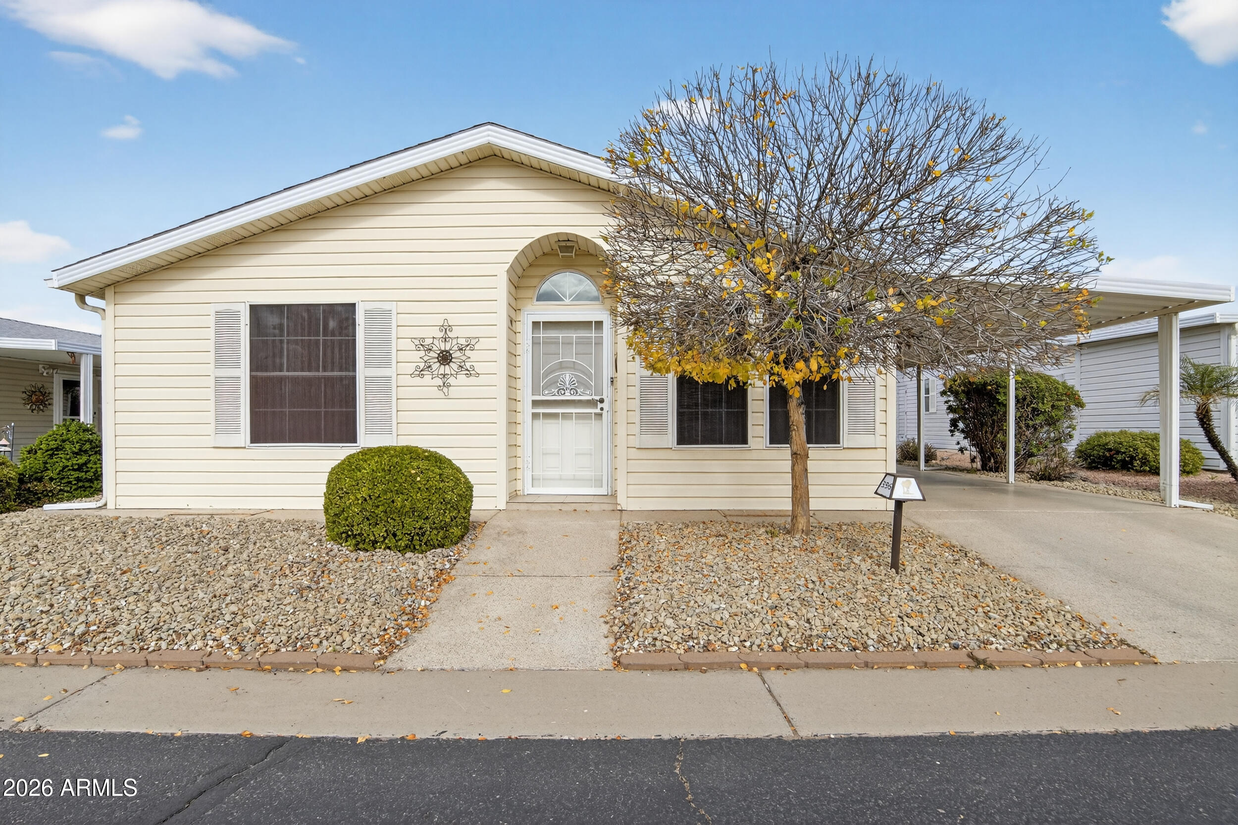 2550 South Ellsworth Road, Unit 396 Mesa, AZ 85209 - Photo 2 of 29 a front view of a house with garden