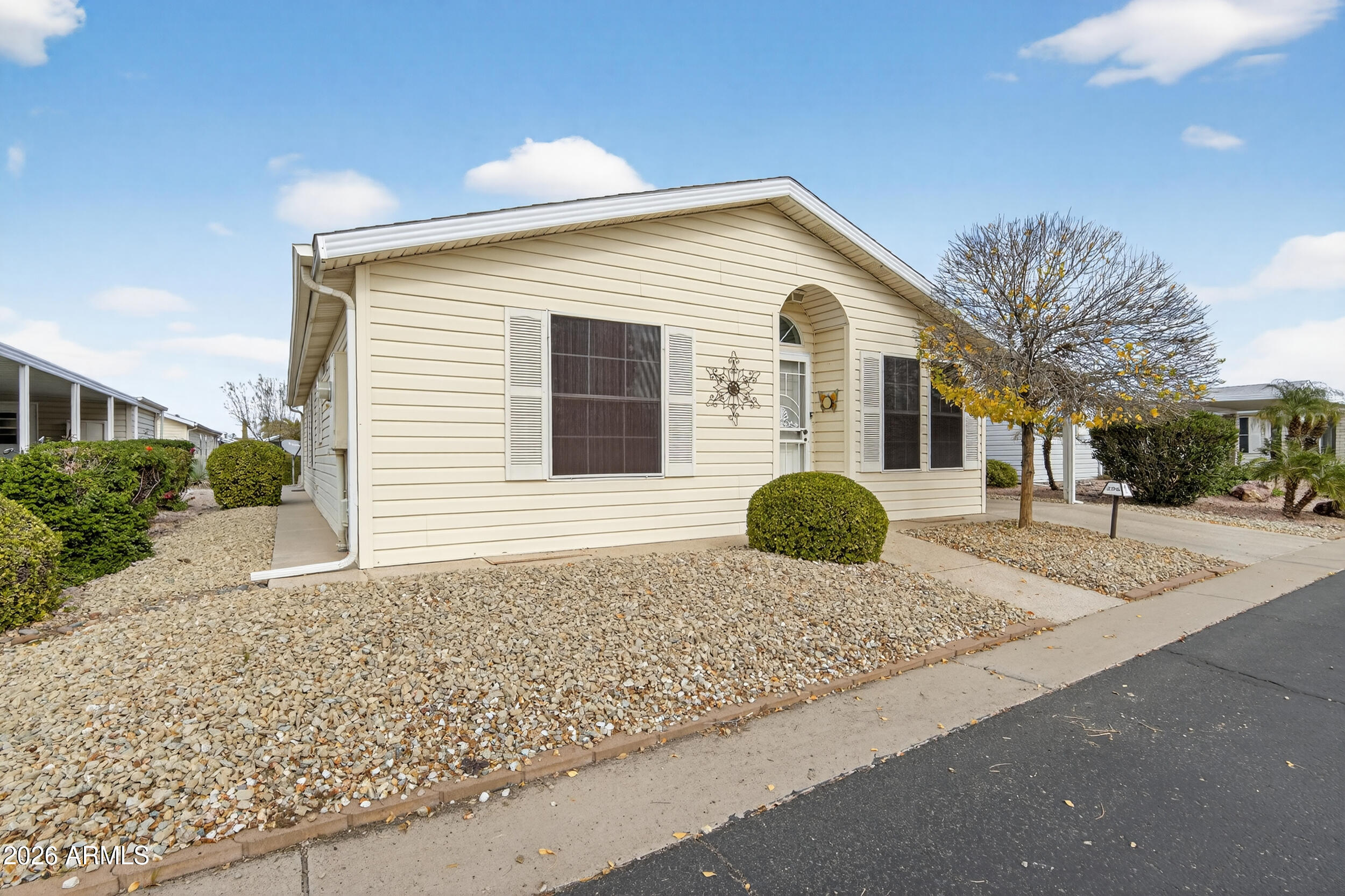 2550 South Ellsworth Road, Unit 396 Mesa, AZ 85209 - Photo 3 of 29 a front view of a house with a yard