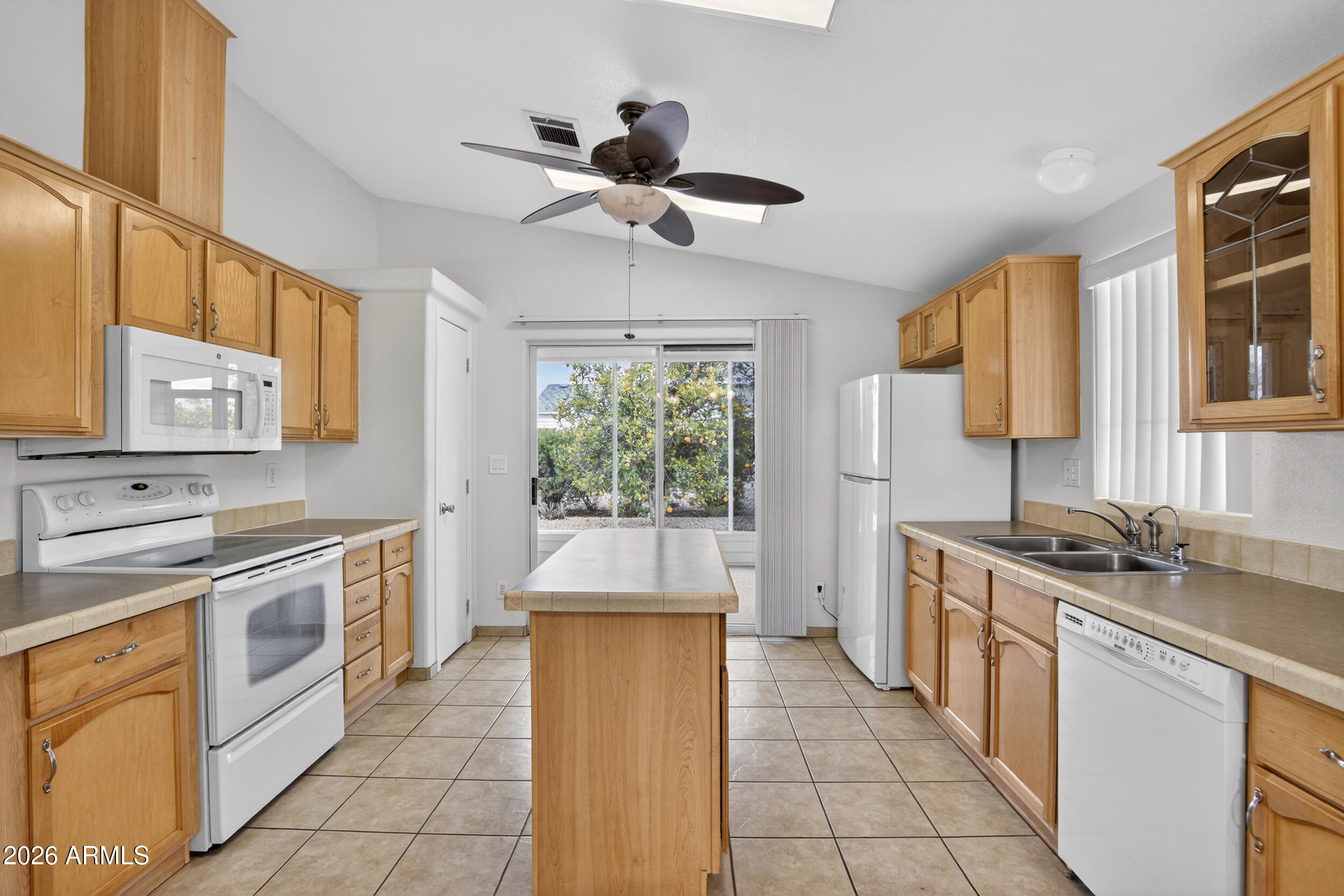 2550 South Ellsworth Road, Unit 396 Mesa, AZ 85209 - Photo 4 of 29 a kitchen with stainless steel appliances granite countertop a stove a sink and a refrigerator