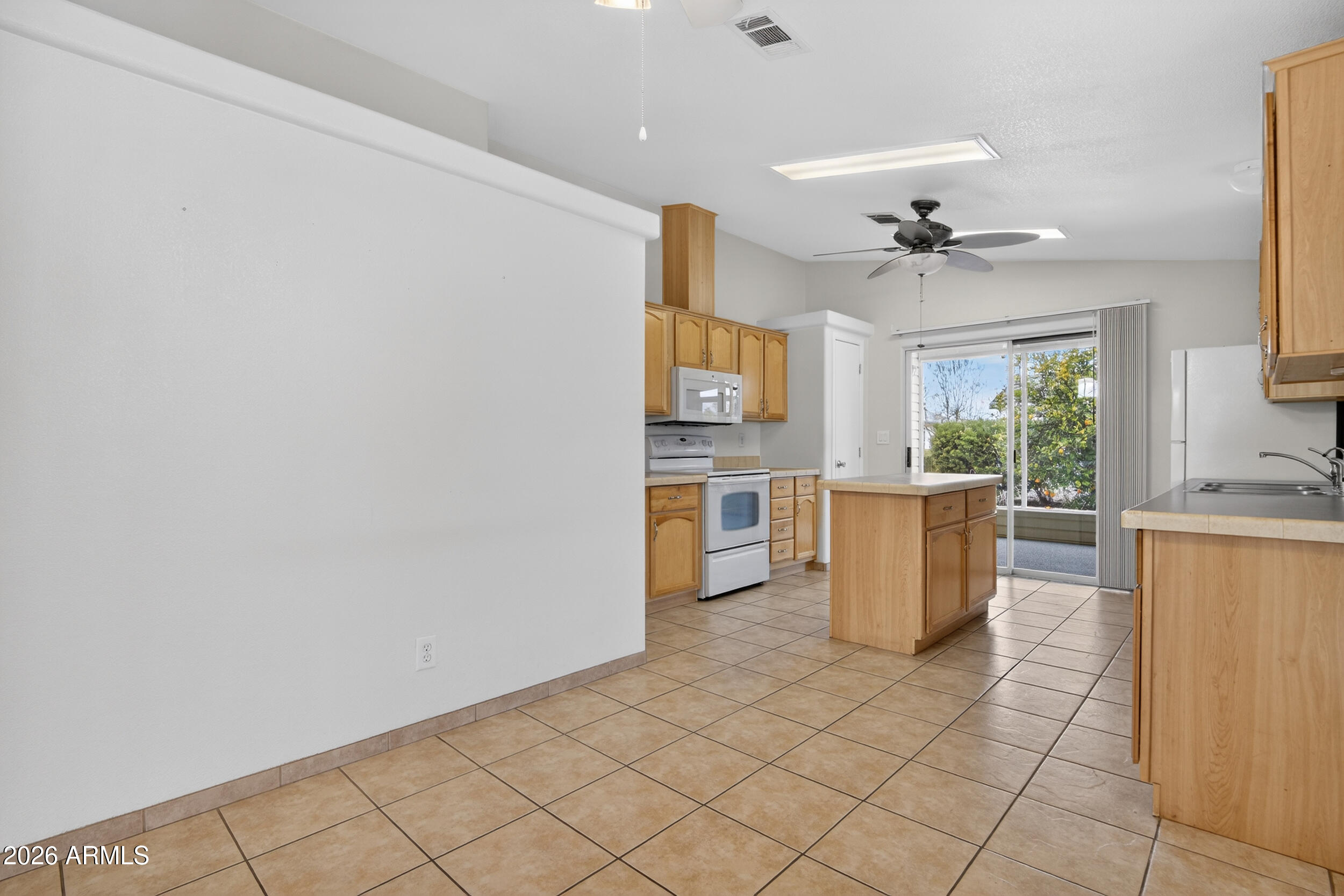 2550 South Ellsworth Road, Unit 396 Mesa, AZ 85209 - Photo 9 of 29 a view of a kitchen with furniture and a window