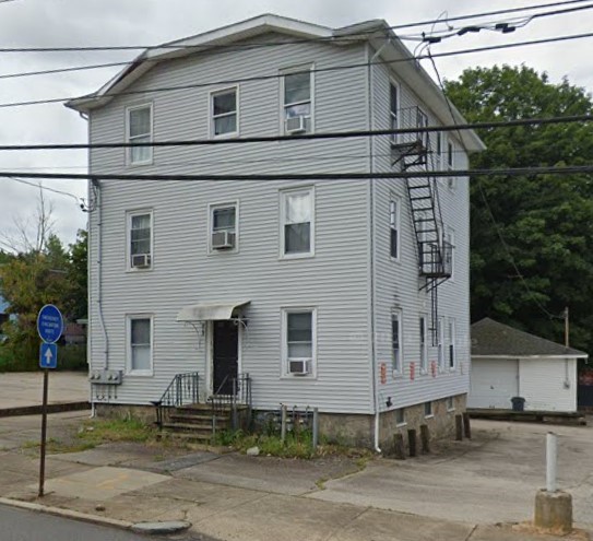 413 Cumberland Hill Road Woonsocket, RI 02895 - Photo 1 of 2 Front of Residential Building with Garage behind.