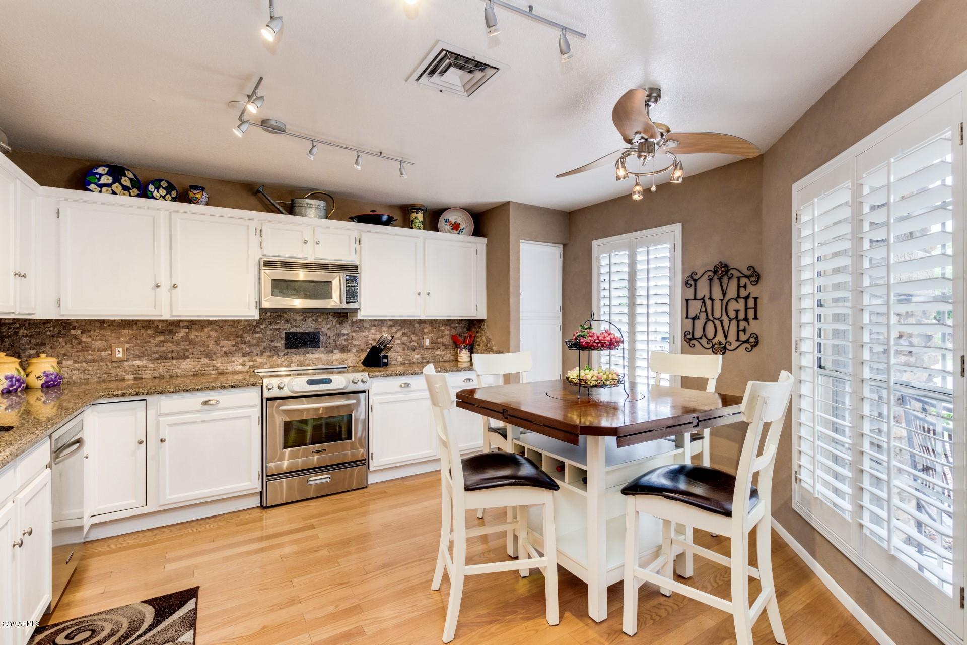 1325 North Rochester Mesa, AZ 85205 - Photo 4 of 21 a kitchen with cabinets appliances and a dining table