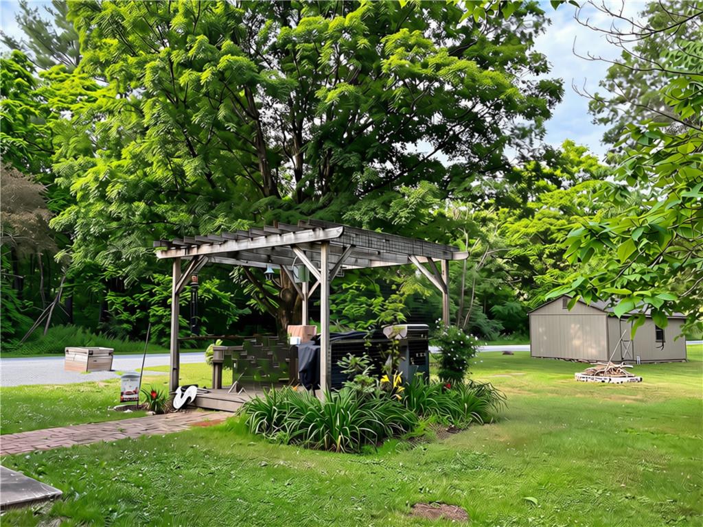 108 Effort Neola Road Effort, PA 18330 - Photo 26 of 31 Relax in the private yard under the pergola, ideal for outdoor gatherings.