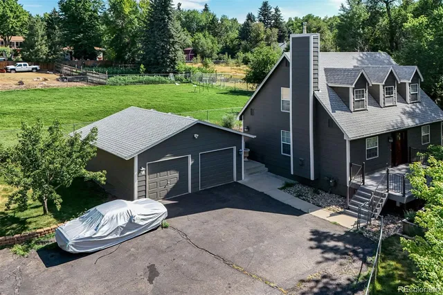 a view of a house with backyard and a patio