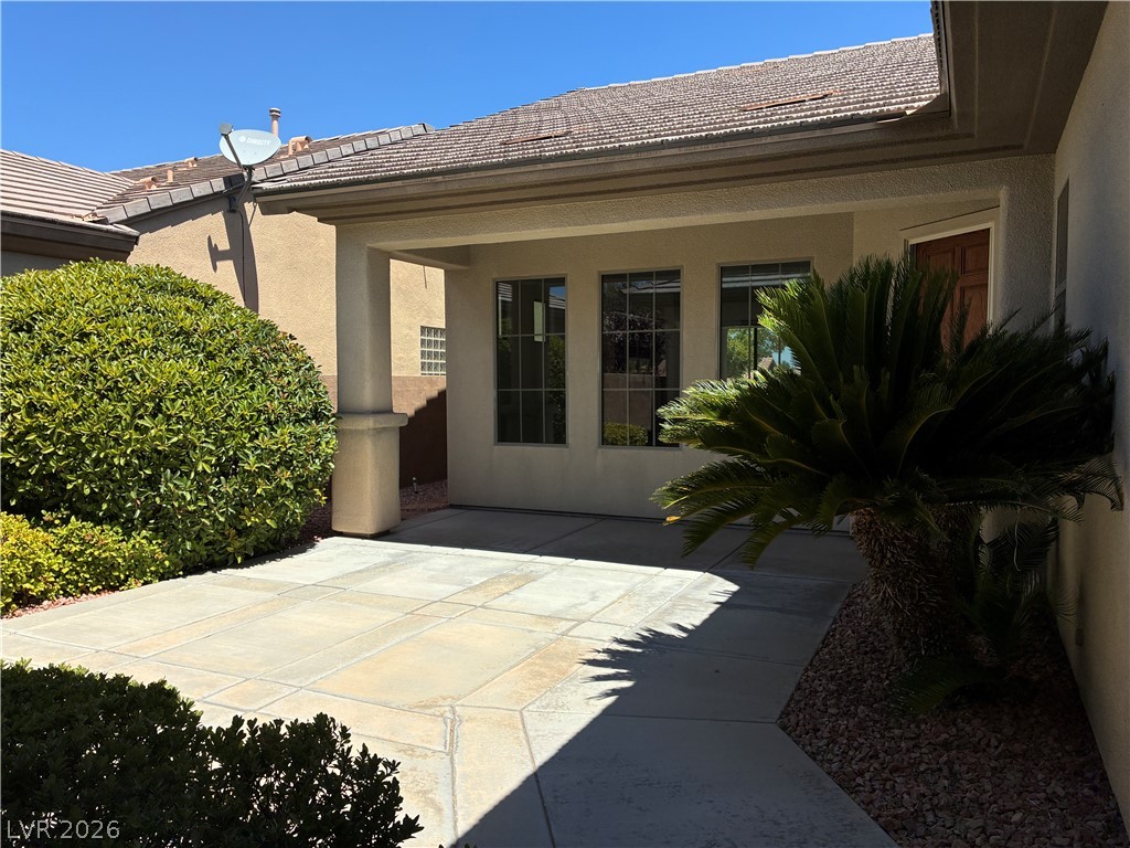 10 Caprington Road Henderson, NV 89052 - Photo 43 of 44 A welcoming front patio offers ample space for outdoor enjoyment and elegant landscaping.