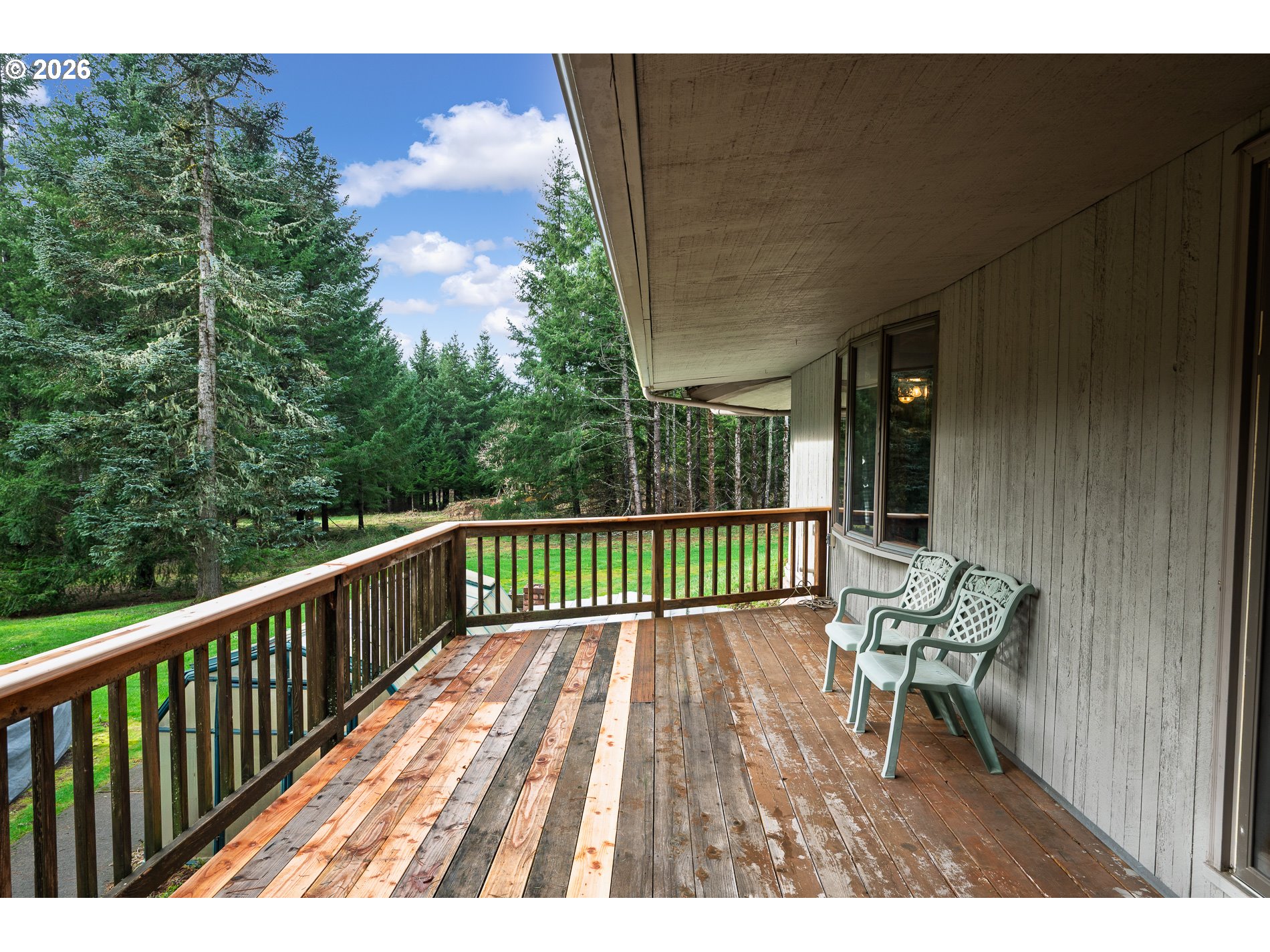 27572 South Kinzy Road Estacada, OR 97023 - Photo 37 of 47 a view of a wooden deck with a bench