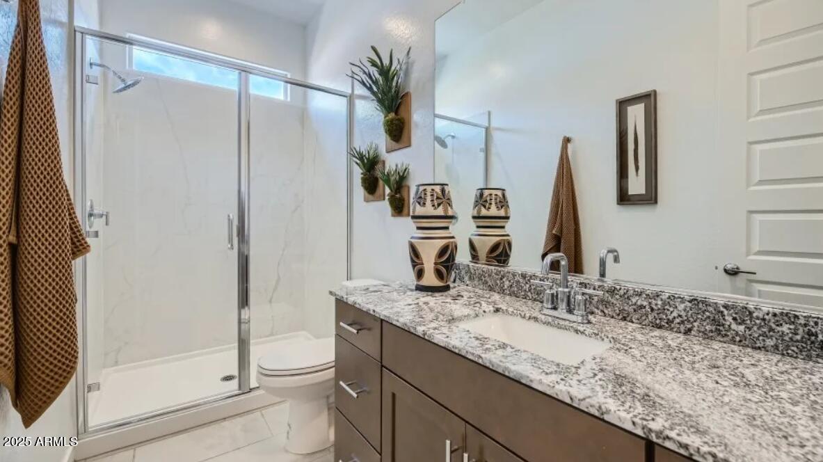 9915 South Dutchman Drive Apache Junction, AZ 85120 - Photo 14 of 27 a bathroom with a granite countertop sink toilet and shower
