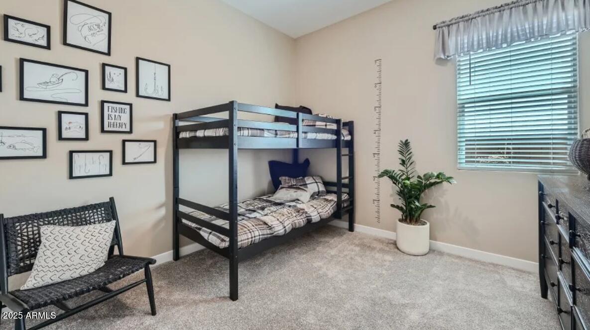 9915 South Dutchman Drive Apache Junction, AZ 85120 - Photo 15 of 27 a bedroom with furniture and a potted plant