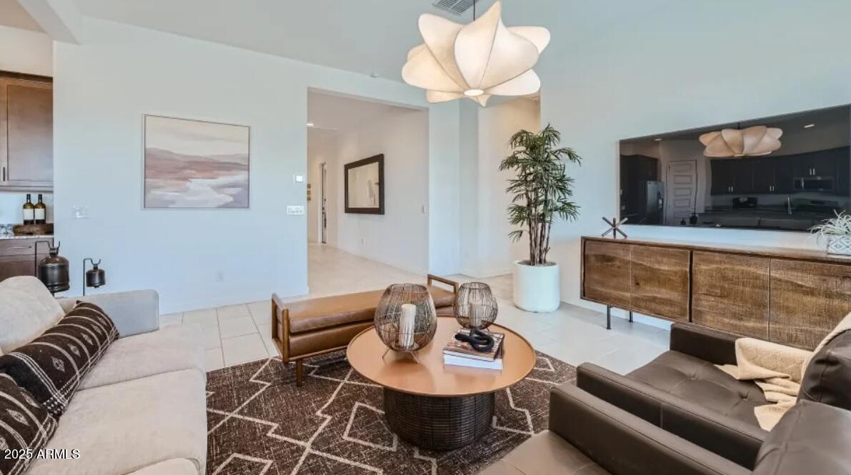9915 South Dutchman Drive Apache Junction, AZ 85120 - Photo 6 of 27 a living room with furniture a flat screen tv and a lamp