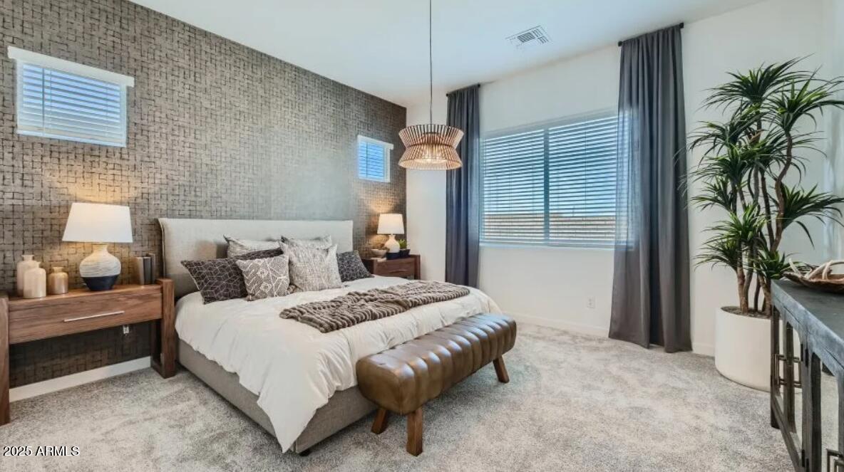 9915 South Dutchman Drive Apache Junction, AZ 85120 - Photo 8 of 27 a bedroom with a bed lamp and a potted plant