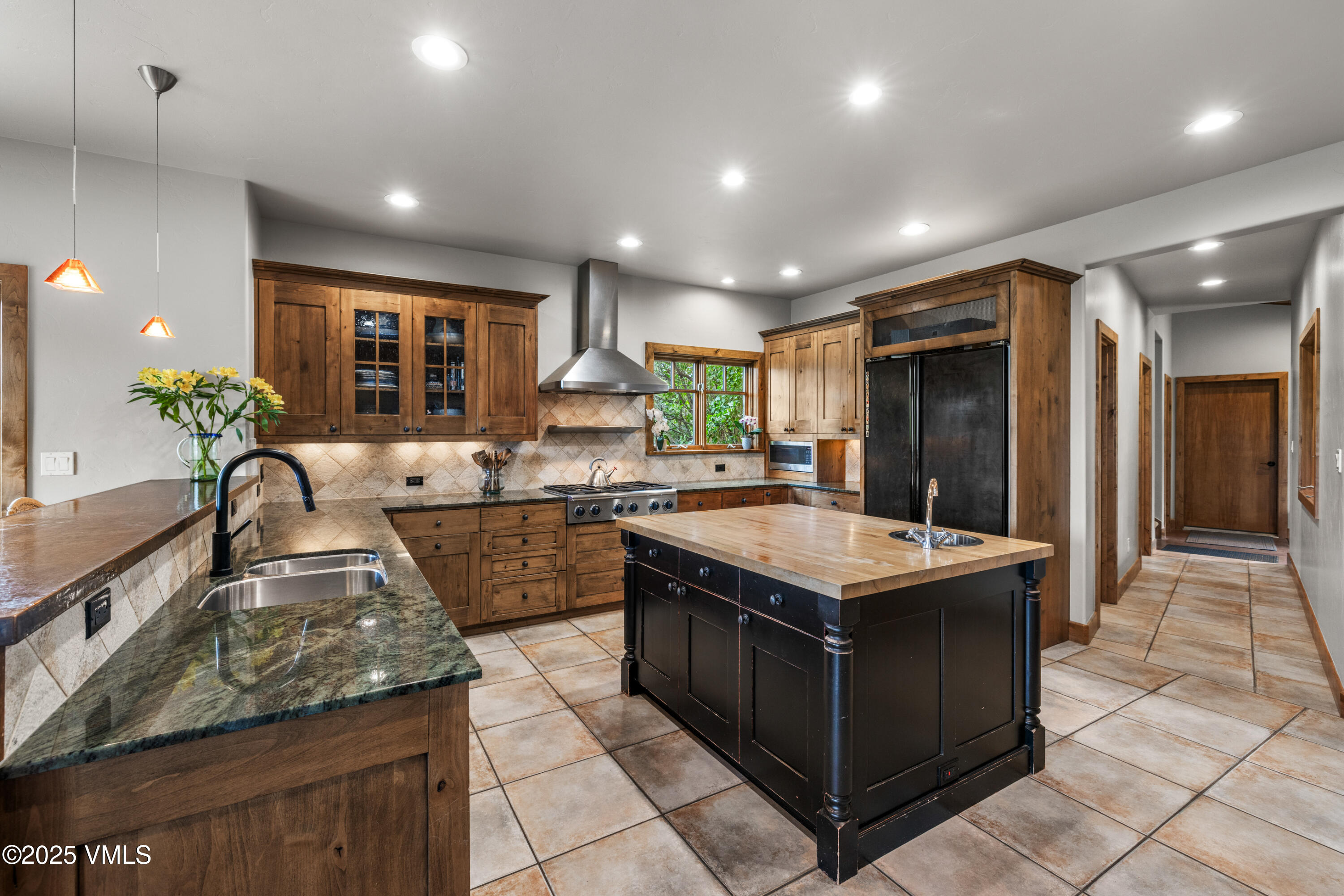 51 Silver Spur Eagle, CO 81631 - Photo 17 of 59 a kitchen with kitchen island granite countertop a sink counter top space and stainless steel appliances