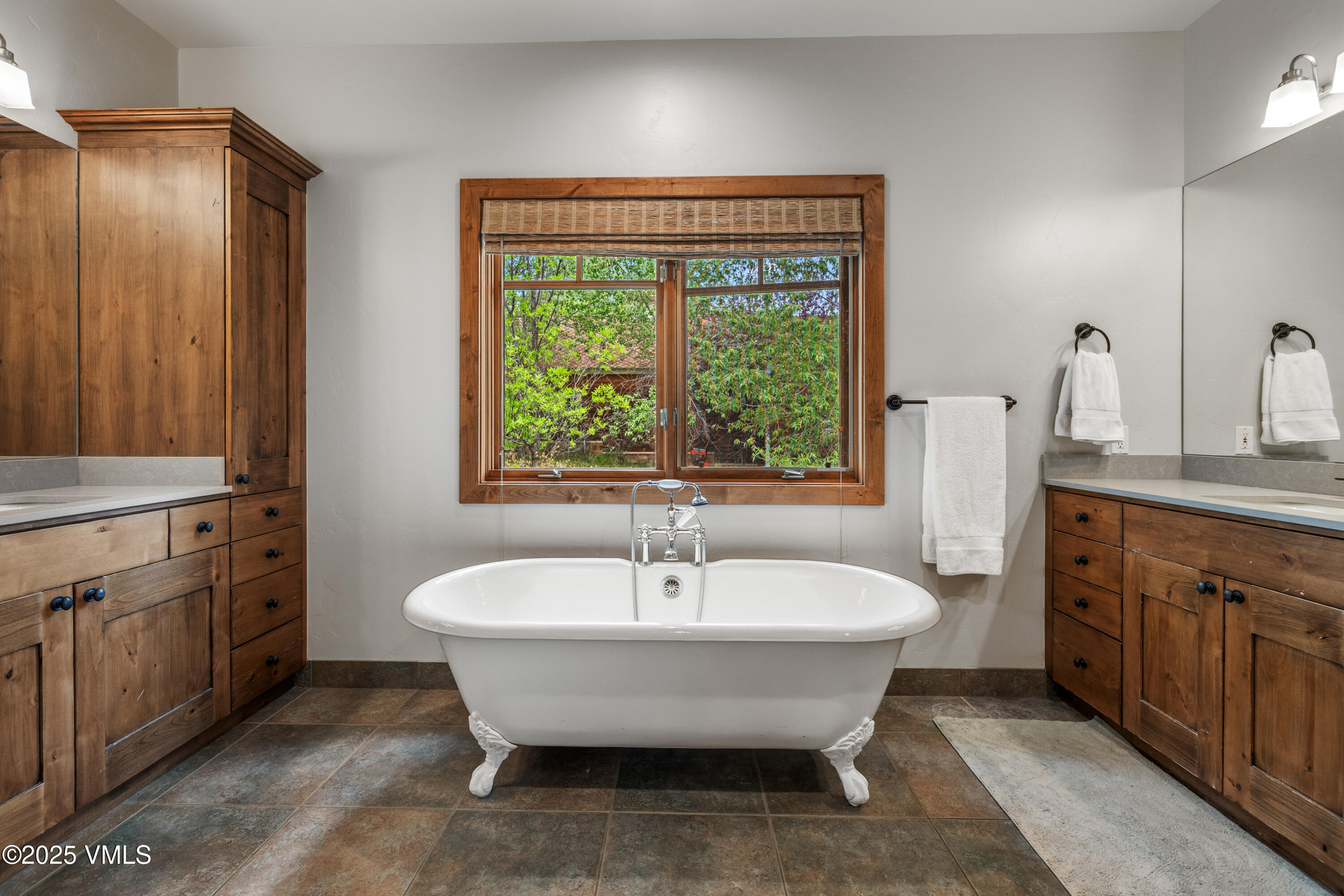 51 Silver Spur Eagle, CO 81631 - Photo 23 of 59 a spacious bathroom with a double vanity sink a two mirror and a tub