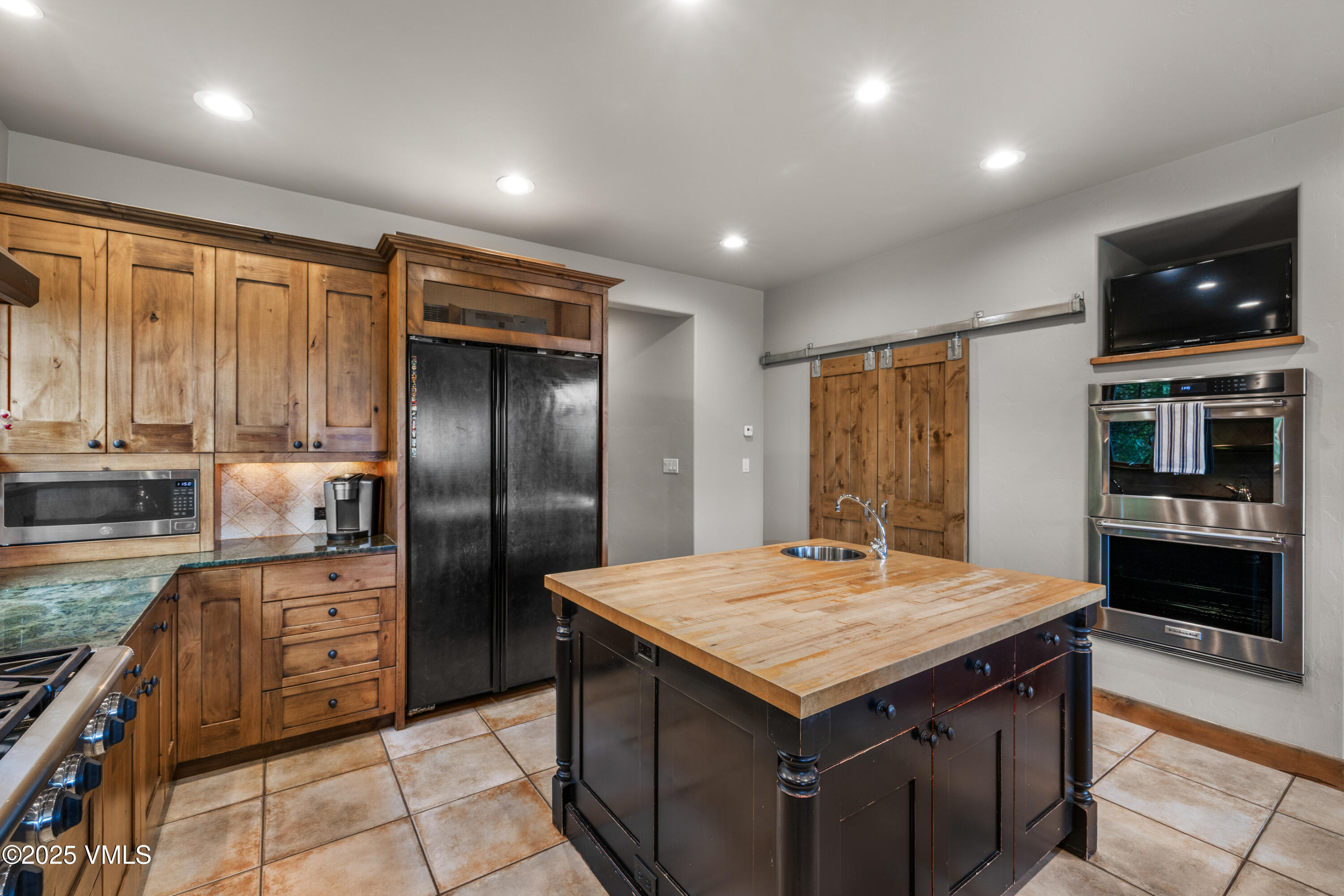 51 Silver Spur Eagle, CO 81631 - Photo 58 of 59 a kitchen with a stove a refrigerator and a sink