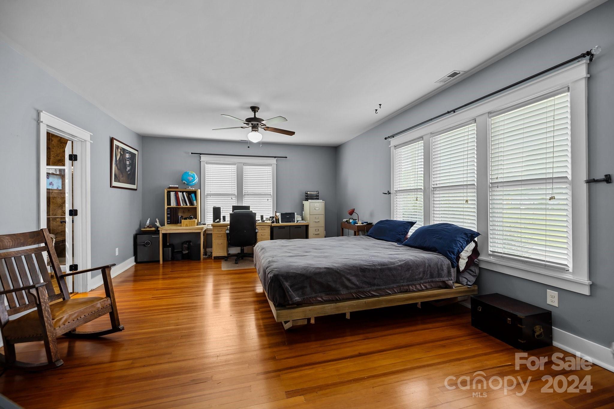 284 8th Avenue Cramerton, NC 28032 - Photo 13 of 29 a spacious bedroom with a bed a table and chair