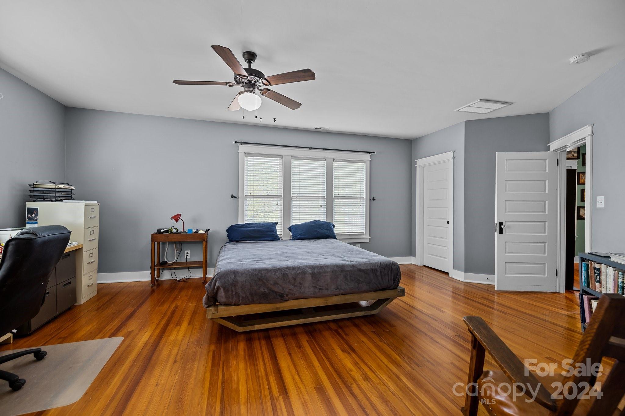 284 8th Avenue Cramerton, NC 28032 - Photo 14 of 29 a bedroom with a bed and wooden floor