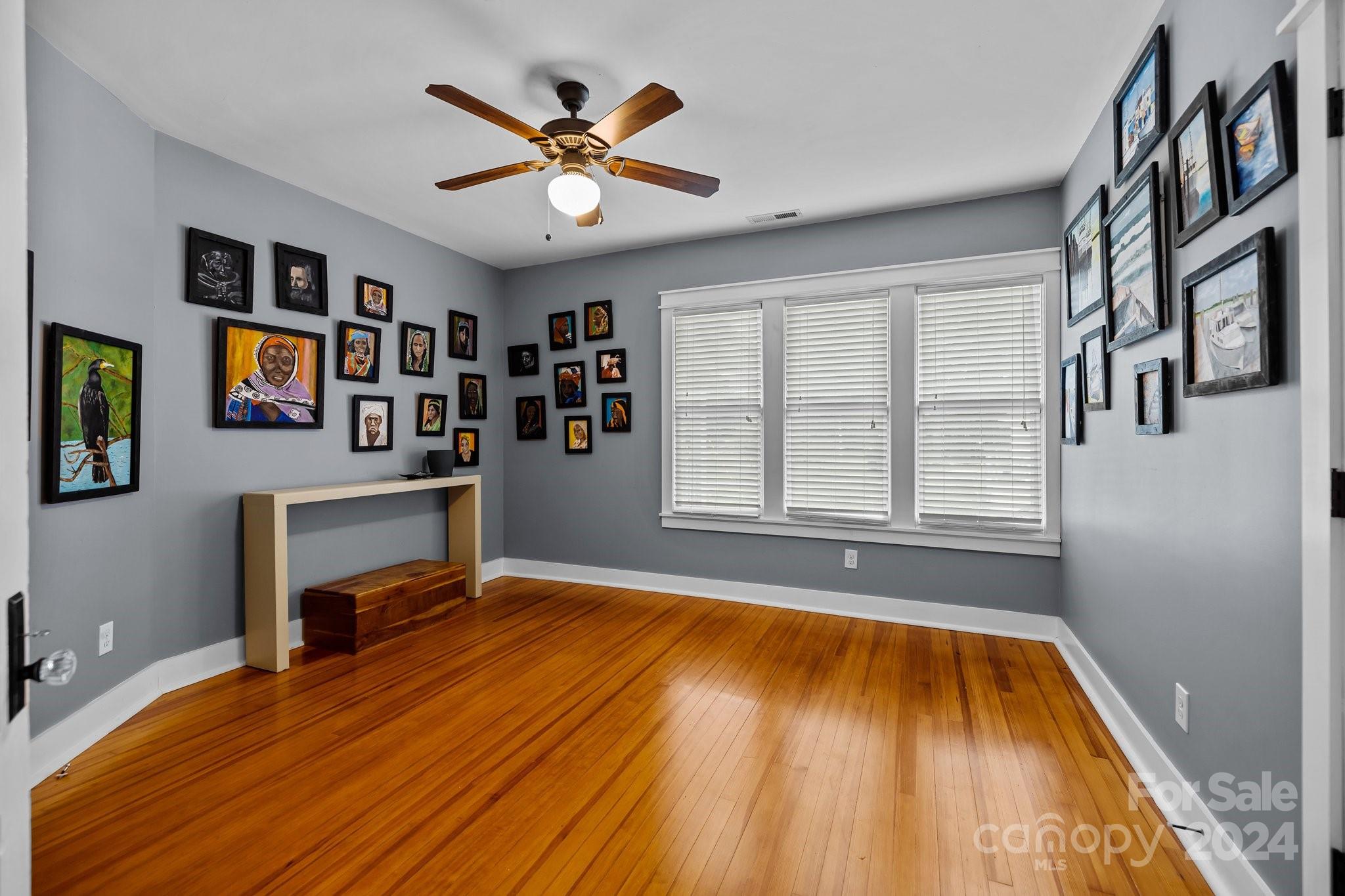 284 8th Avenue Cramerton, NC 28032 - Photo 17 of 29 a view of an empty room with a window and wooden floor