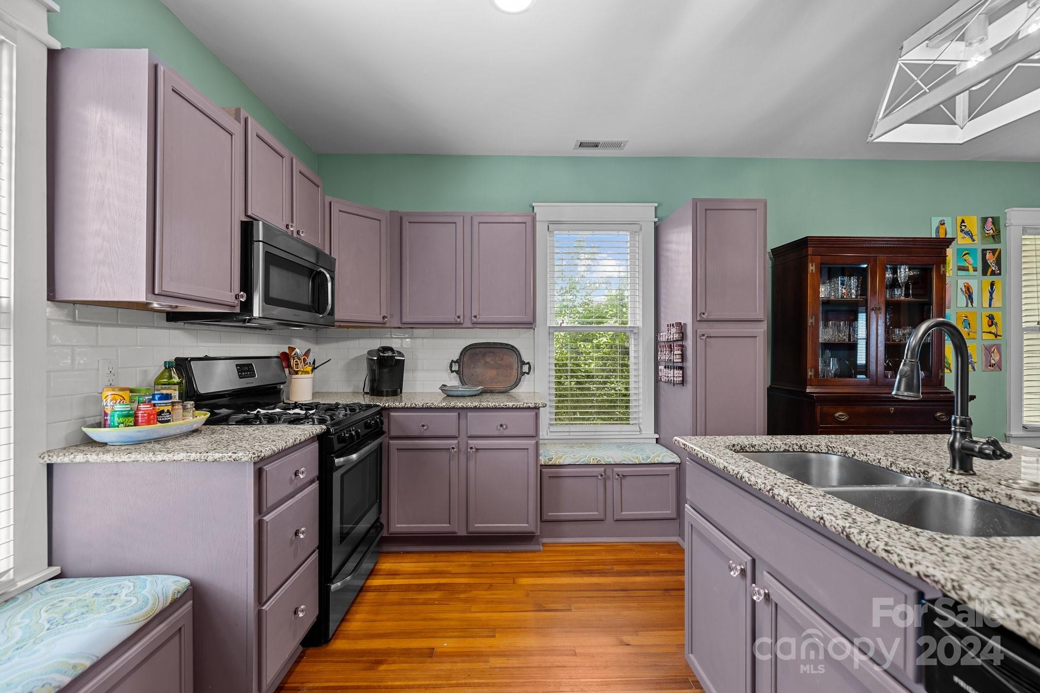 284 8th Avenue Cramerton, NC 28032 - Photo 7 of 29 a kitchen with stainless steel appliances granite countertop a sink stove and cabinets