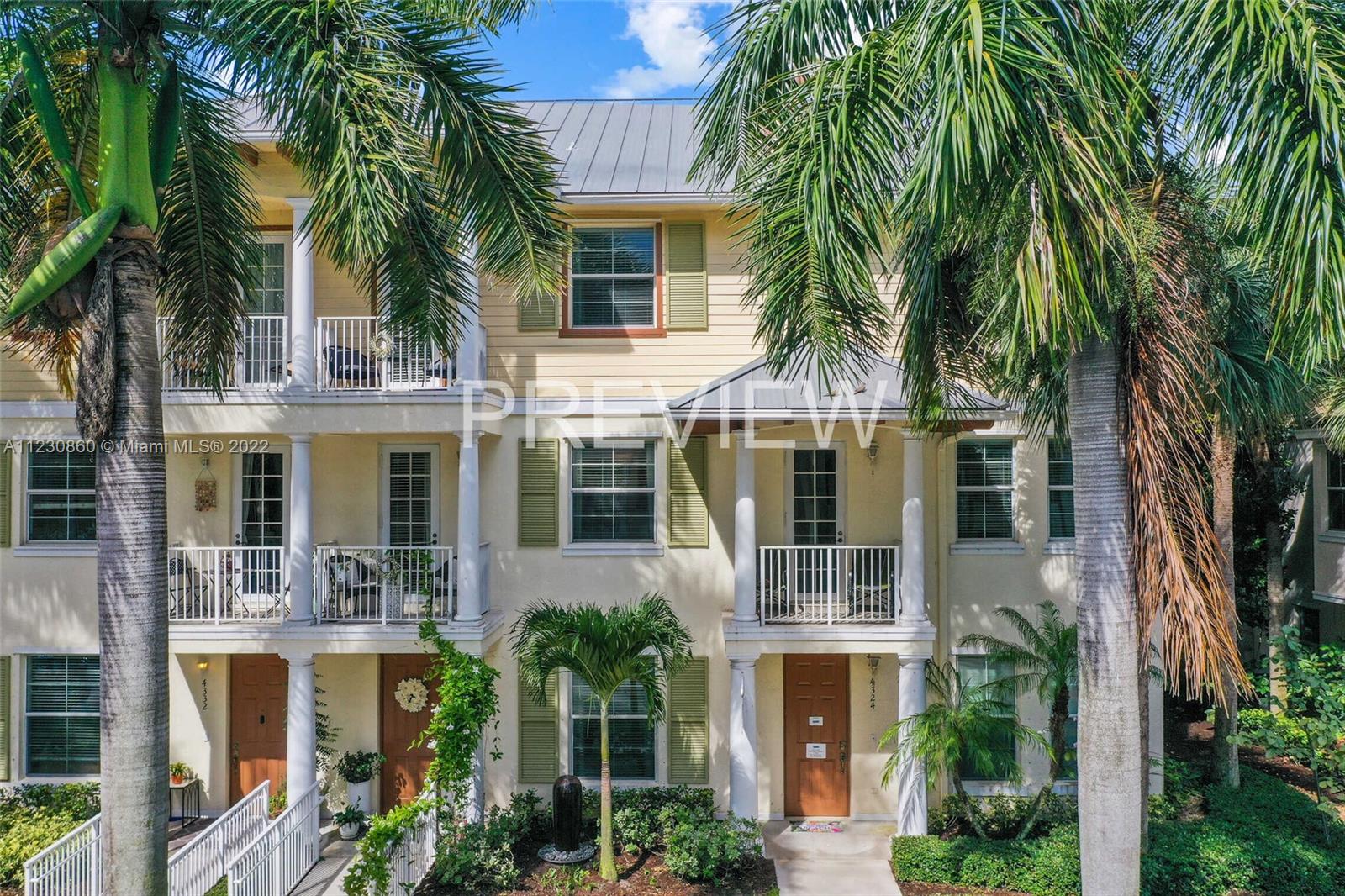 4332 Main Street Jupiter, FL 33458 - Photo 1 of 28 front view of house with a palm tree